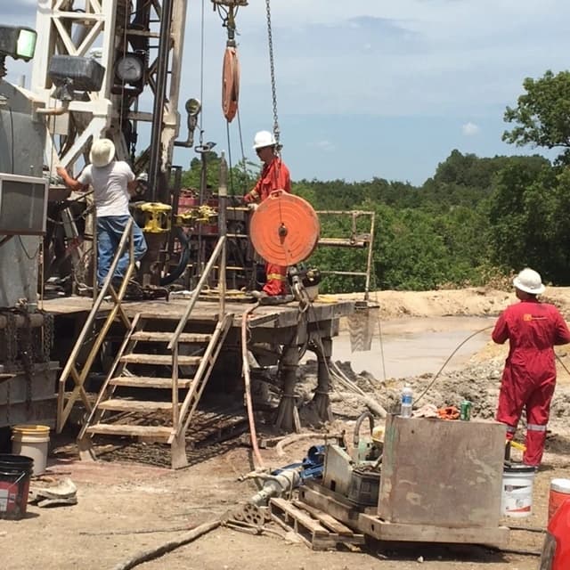 Field crew working on a drilling rig during oil and gas operations